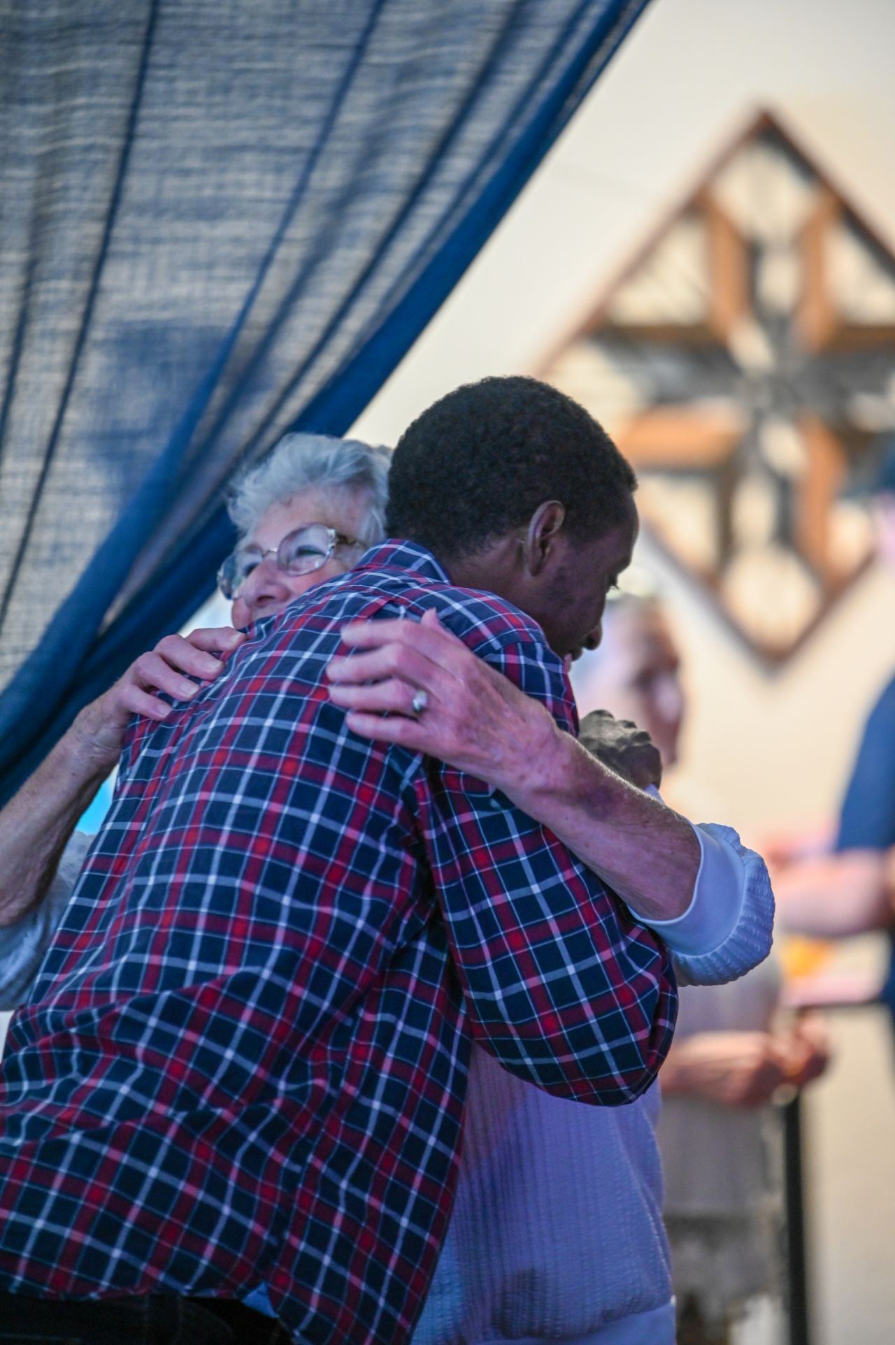 Two church members sharing a warm hug